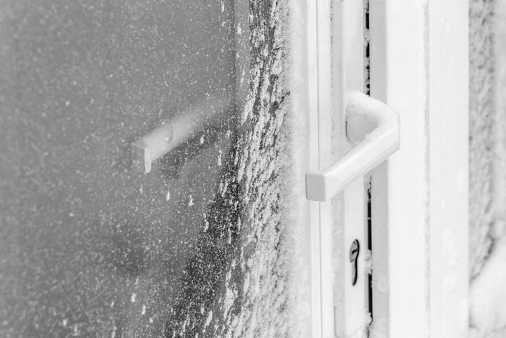 Storm door protecting entry door from a snow storm Storm door protecting entry door from a snow storm